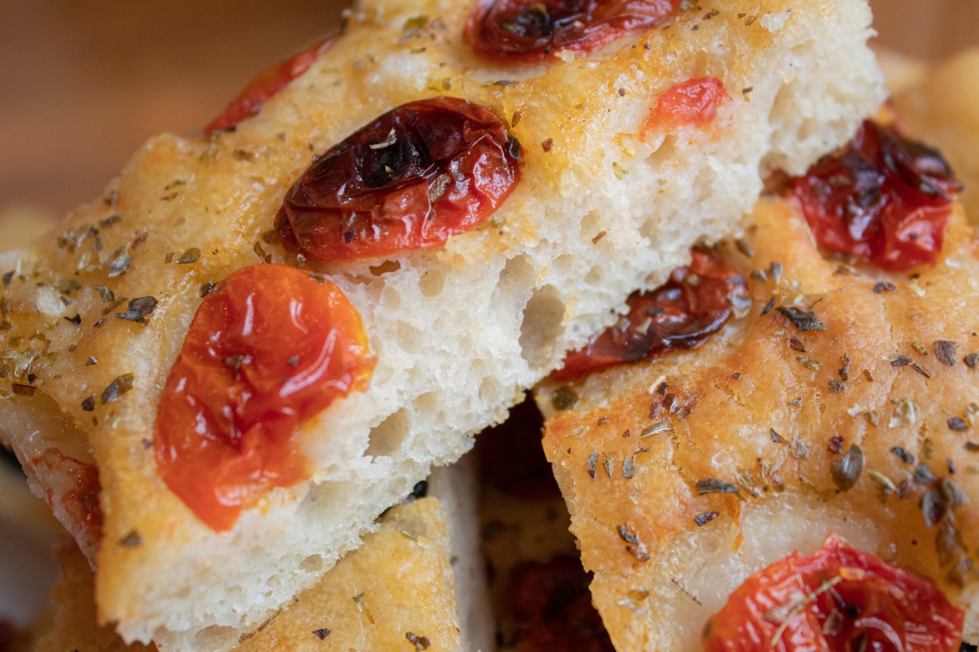 Golden focaccia studded with roasted tomatoes and herbs